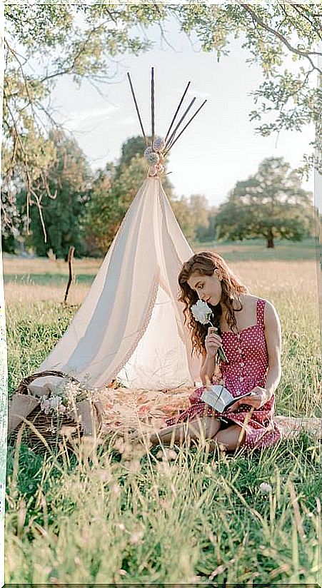 Woman with tent in field